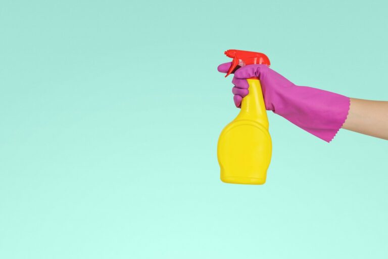 Cleaning glove and spray bottle representing professional commercial cleaning services in Maine