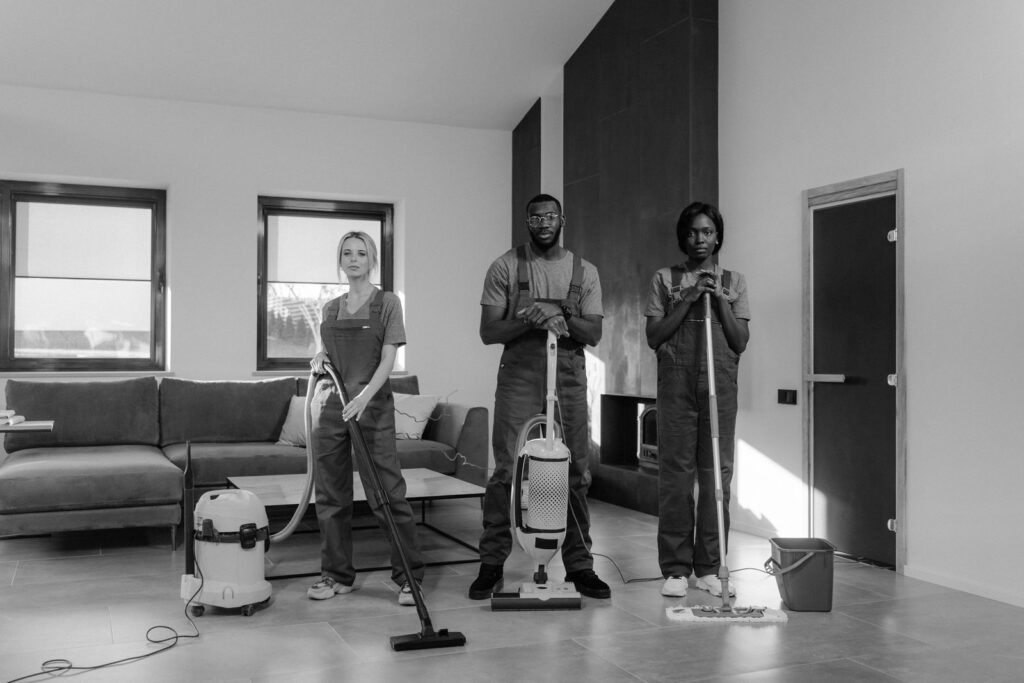 Commercial cleaning crew preparing a Maine office building for fall, polishing floors in a bright lobby with autumn light through windows
