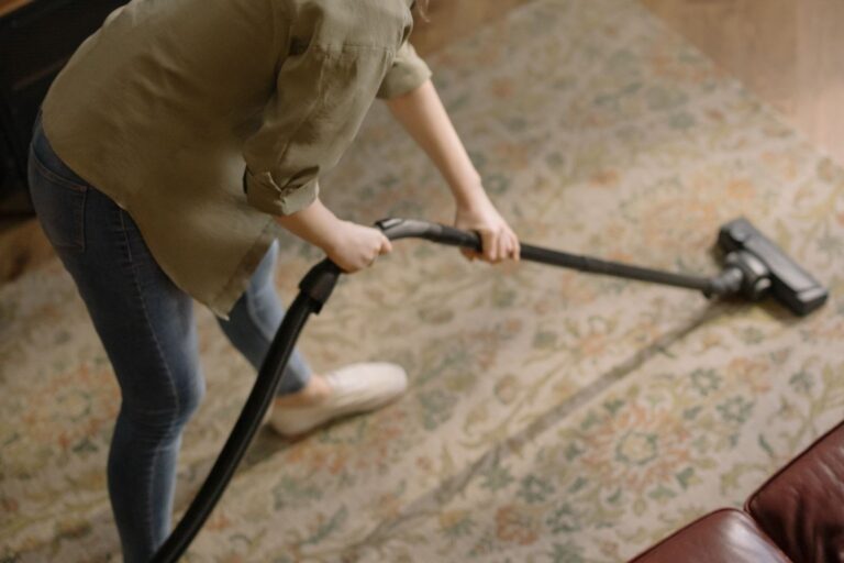 Professional cleaner vacuuming commercial carpet in a Maine office building during fall deep cleaning service